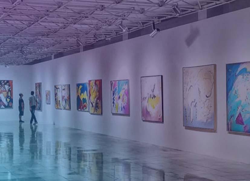 Image showing art paintings hung on walls at an art show event.