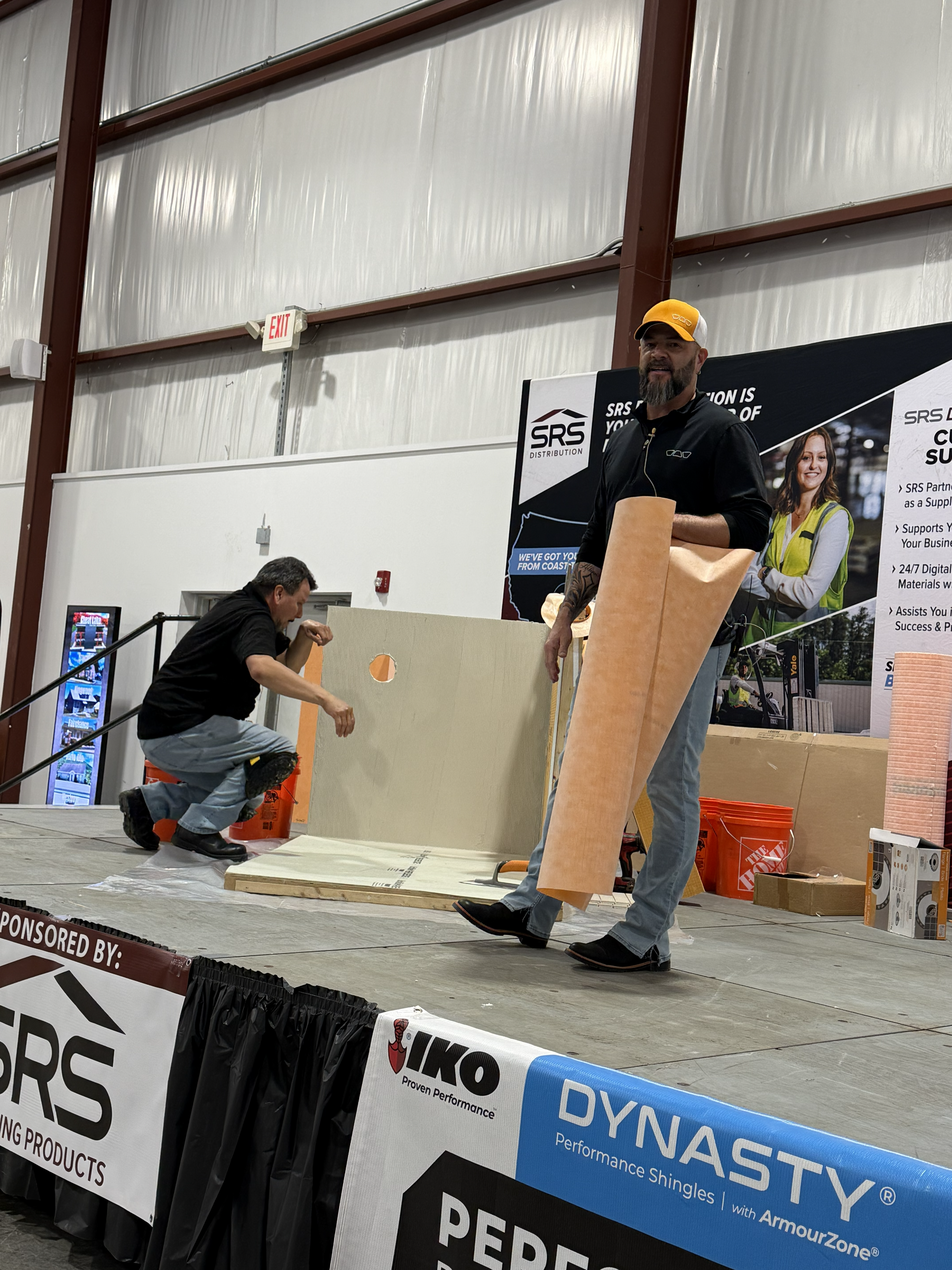 Presenters giving a live building demonstration on stage at the NCWVHBA Home Show.